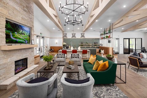 a living room with couches and chairs and a fireplace
